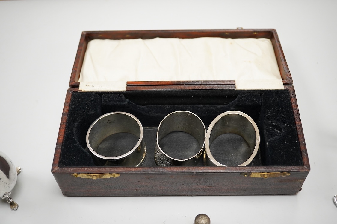 Three assorted 20th century silver napkin rings, a George V silver mustard pot and pepperette, a set of six late Victorian silver coffee spoons, London, 1883, and six other silver items.